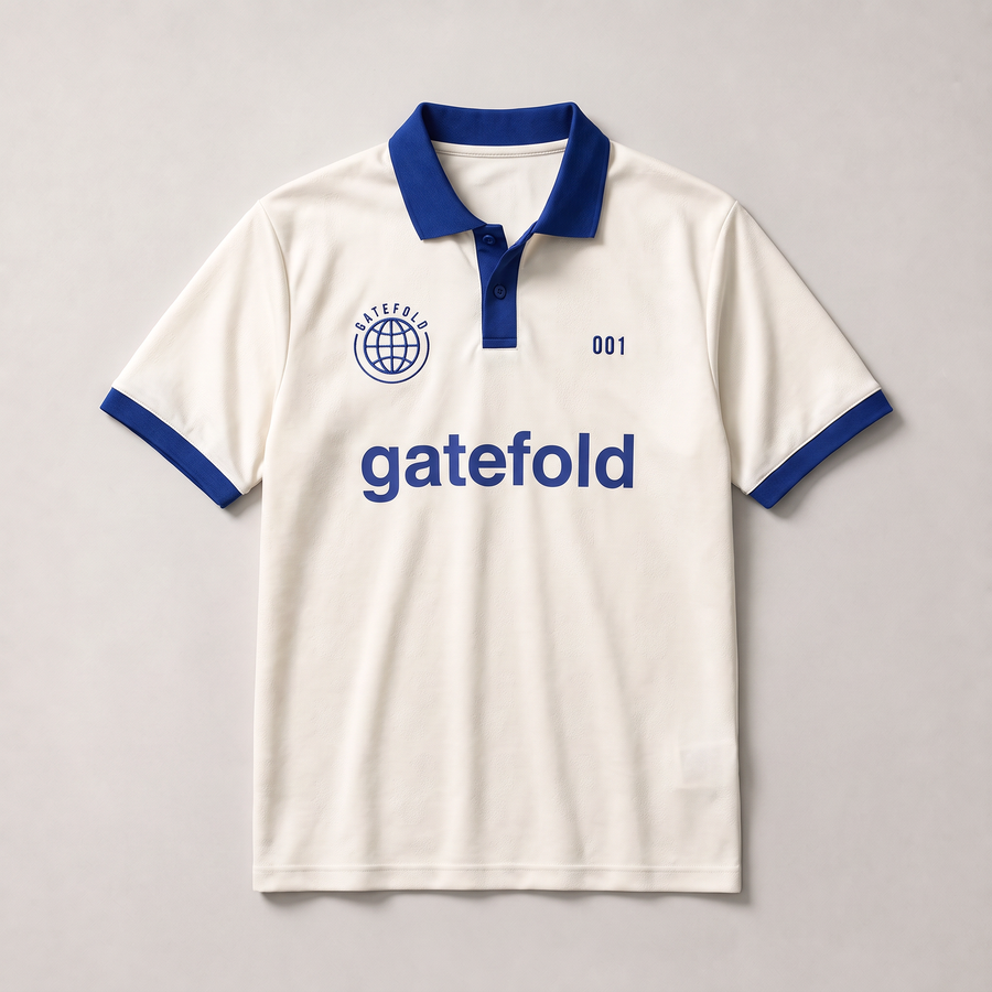 Off-white 1990s football shirt with cobalt collar and cuffs, embroidered globe crest, 001 and the gatefold sponsor